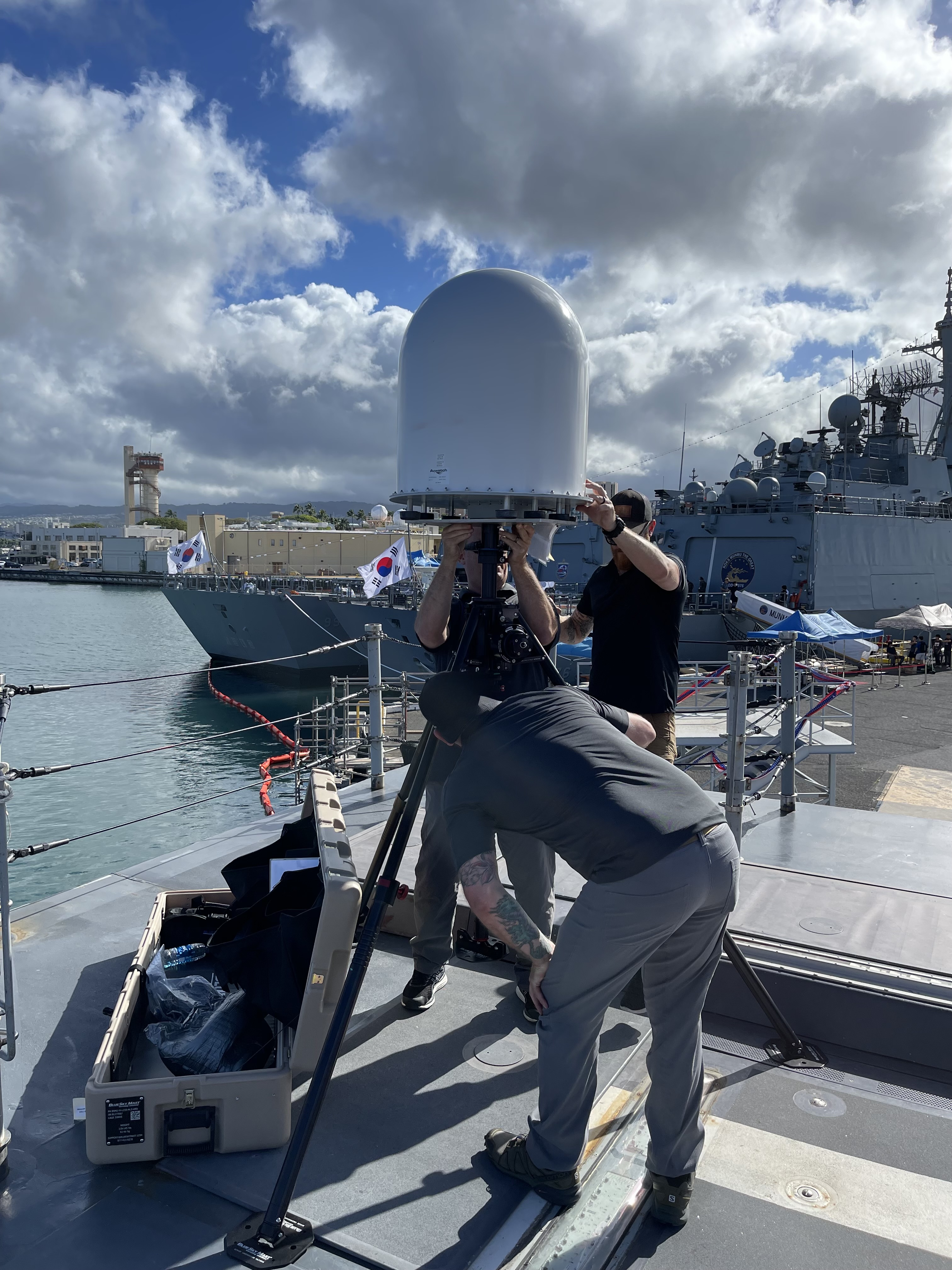 Team setting up radar equipment on naval vessel
